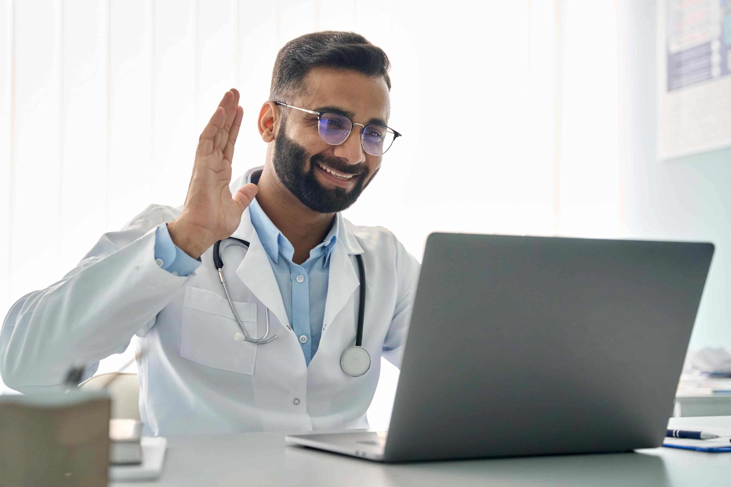 EC - Image - Stock - Physician Waving on Computer (1)